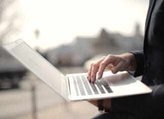 Specjalista pracuje na laptopie na zewnątrz, praca zdalna na Windows